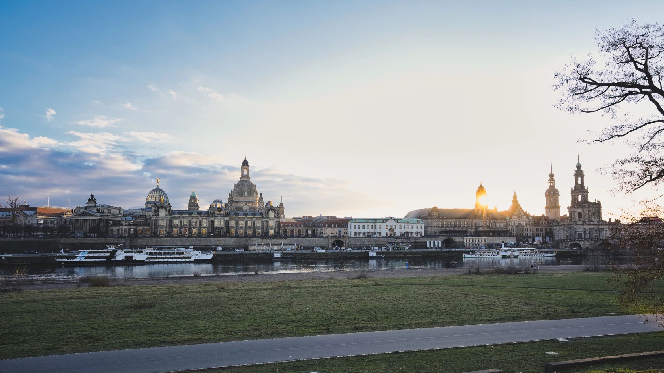 Dresden skyline at golden hour with historic architecture reflected in the river